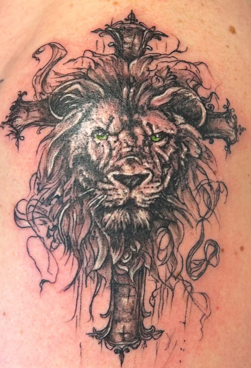 Black-and-grey lion and cross custom tattoo by Pete Calcagno in West Milford NJ